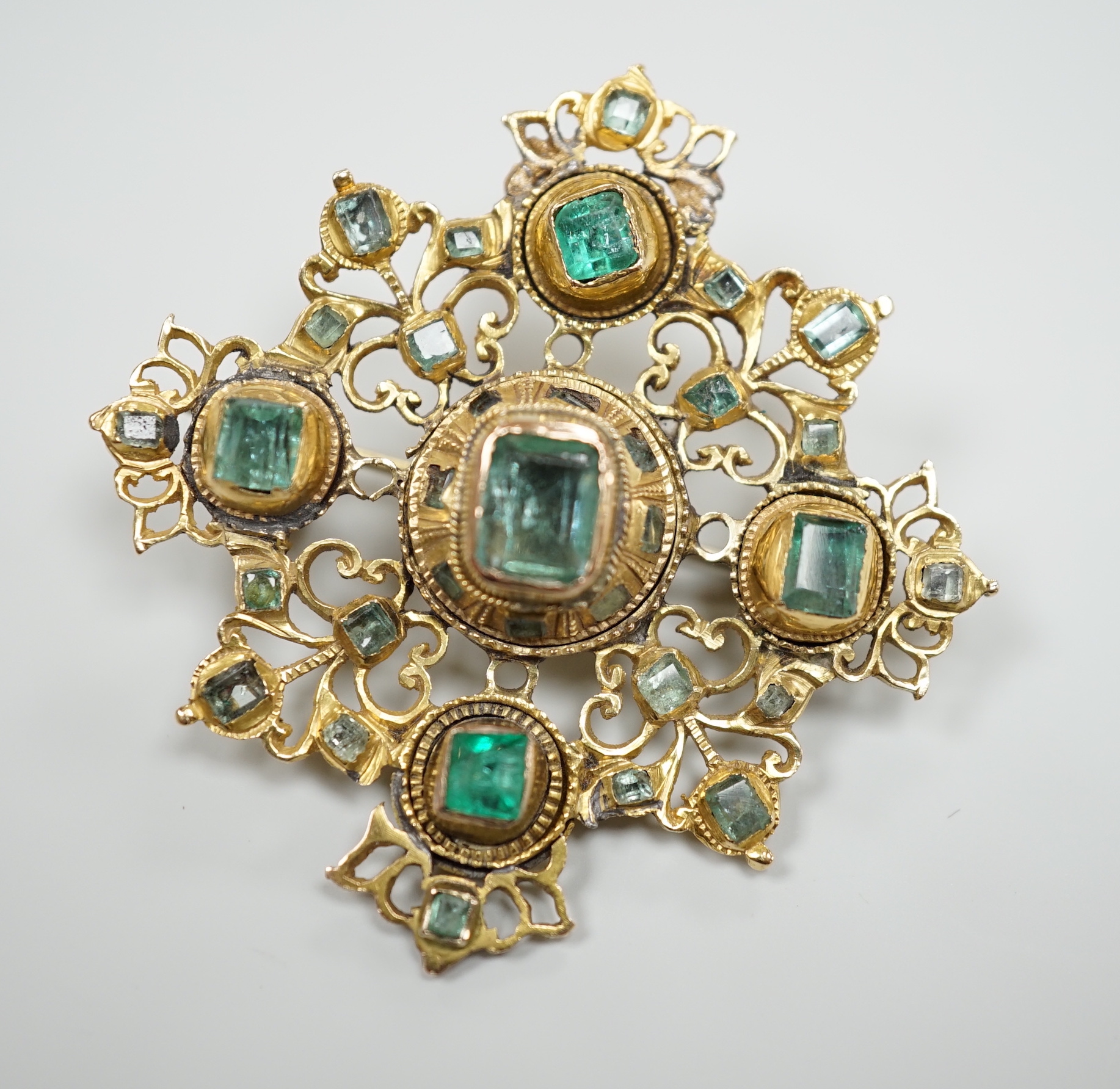 A 19th century continental pierced yellow metal and emerald cluster set quatrefoil brooch, 47mm